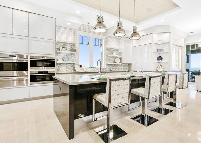 Kitchen with large island and barstools.